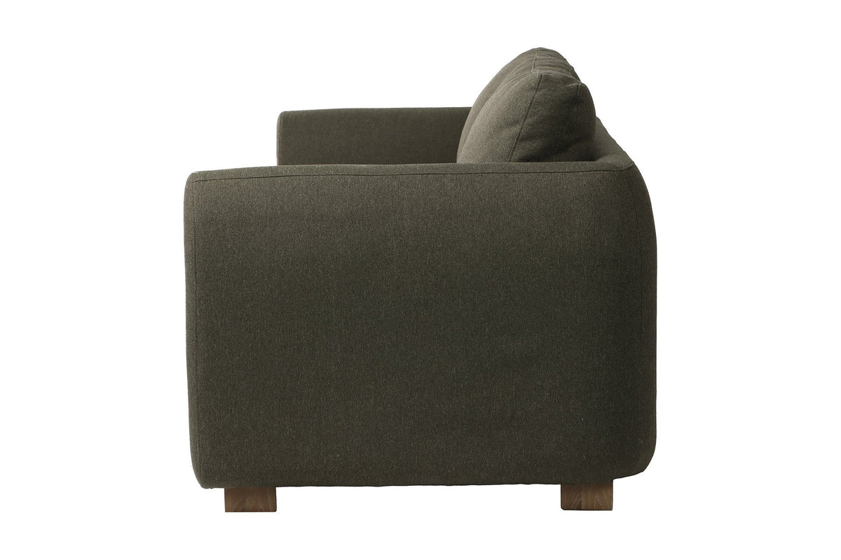 Isolde sofa side view showing the rounded arm and ash wood legs