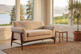 Jesi loveseat in a Kelowna lake house sunroom with a jute rug, a rush stool and a view of the lake and vineyard hills