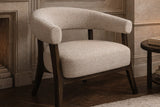 Jolie oat fabric armchair in a panelled sitting room beside a side table