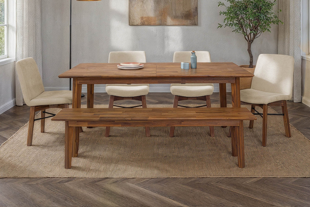 Keaton Warm Pecan dining table with a bench and cream chairs in a bright dining room