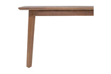 Corner of the Keaton dining table showing the apron and a slim square leg