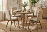 Keaton Light Driftwood round dining table set for four in a sunlit dining room