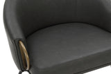 Close-up of the Kenna bucket seat, charcoal faux leather and aged gold arm ring