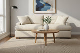 Kingsley Sand queen sofa bed in a bright living room with a round wood coffee table