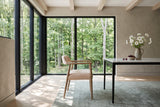 A Laigueglia armchair in Beige leather in side profile in a King Township forest house