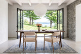 Two Laigueglia armchairs in Beige leather seen from behind at a walnut table in a Knowlton house