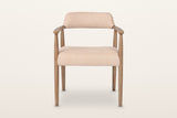 Laigueglia dining armchair in Beige leather, straight front view on a warm white studio backdrop: the back band
