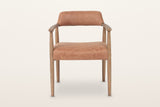 Laigueglia dining armchair in Brown leather, straight front view on a warm white studio backdrop