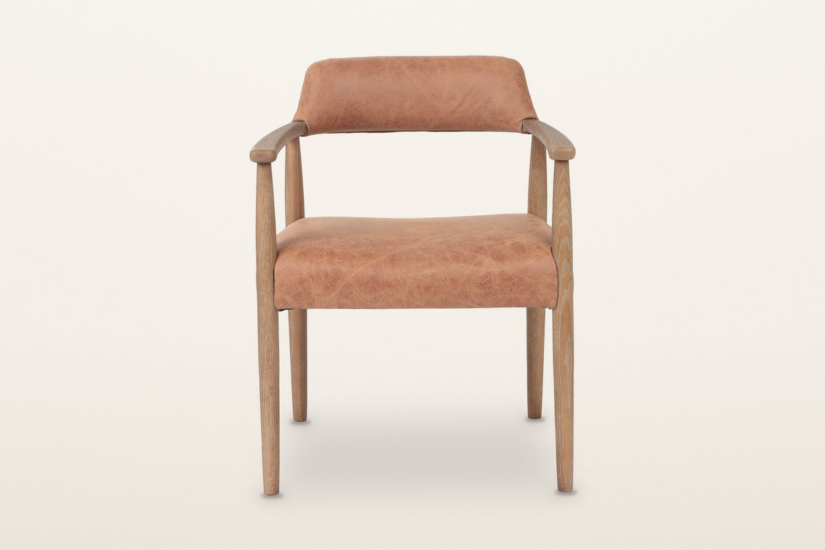 Laigueglia dining armchair in Brown leather, straight front view on a warm white studio backdrop