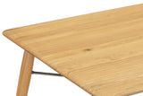 Close-up of a Larino corner in Natural: the rounded corner, the soft edge and a splayed leg
