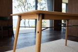 Larino legs in Natural at seat height in the Victoria house: a black bracket, a bolt head and the forked black rods