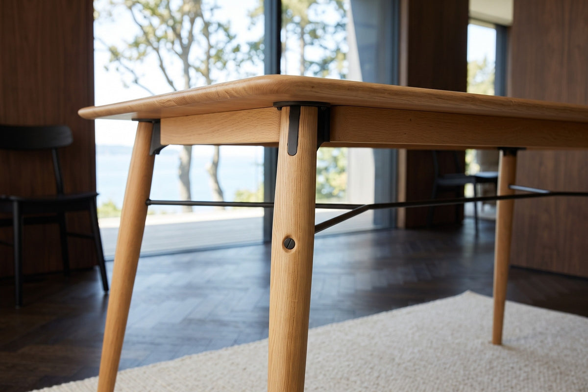 Larino legs in Natural at seat height in the Victoria house: a black bracket, a bolt head and the forked black rods