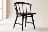 Lauryn dining chair in black oak on a studio backdrop, front three-quarter view