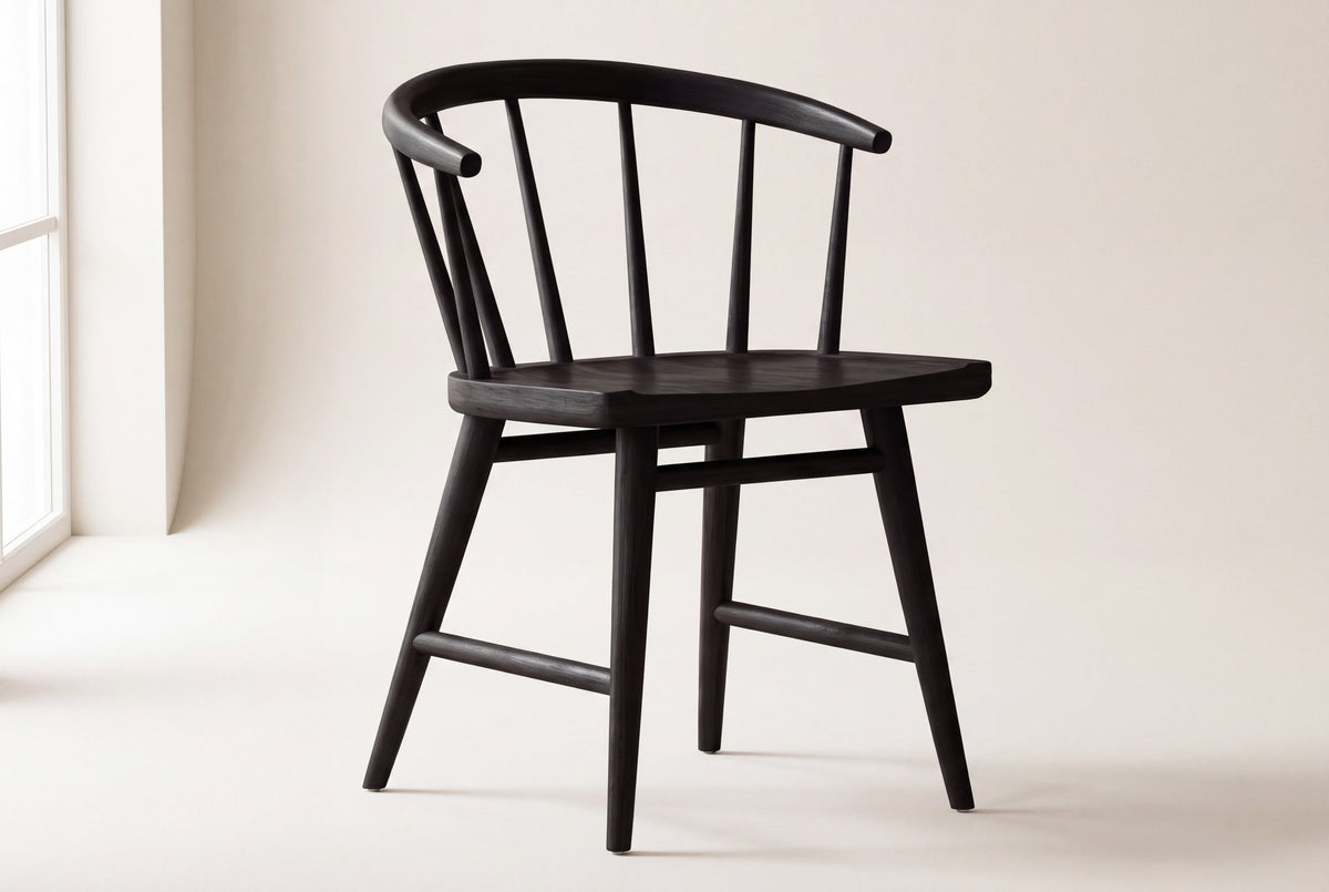 Lauryn dining chair in black oak on a studio backdrop, front three-quarter view