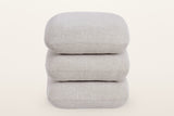Lavagna square ottoman in Beige from the front: three pillows stacked squarely, each with one fine seam