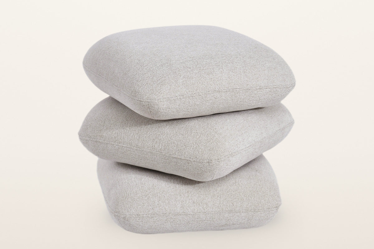 Lavagna ottoman in Beige with the top two pillows turned at an angle: they swivel