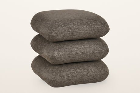 Lavagna square ottoman in Brown, three-quarter view on a warm white studio backdrop: three soft square pillows stacked