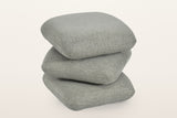Lavagna ottoman in Sage with the top two pillows turned at an angle: they swivel