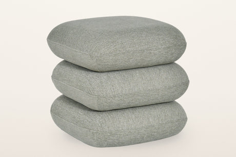 Lavagna square ottoman in Sage, three-quarter view on a warm white studio backdrop: three soft square pillows stacked