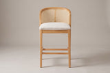 Lazise counter stool in Natural, straight front view: a low curved cane-look back above a padded beige seat