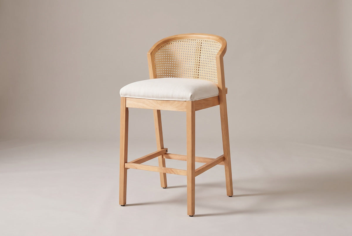 Lazise counter stool in a Natural finish, three-quarter view on a warm grey studio backdrop
