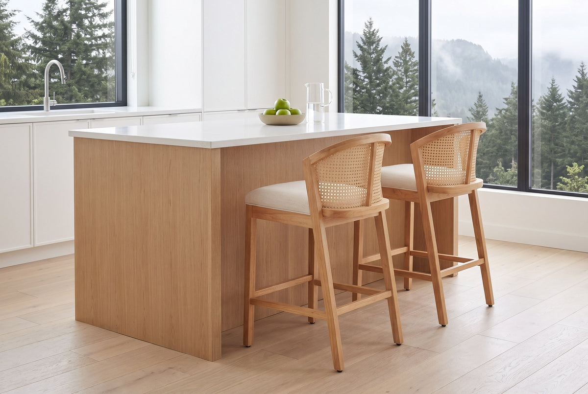 Two Lazise counter stools at a white-oak kitchen island in a bright Vancouver kitchen with cedar trees outside