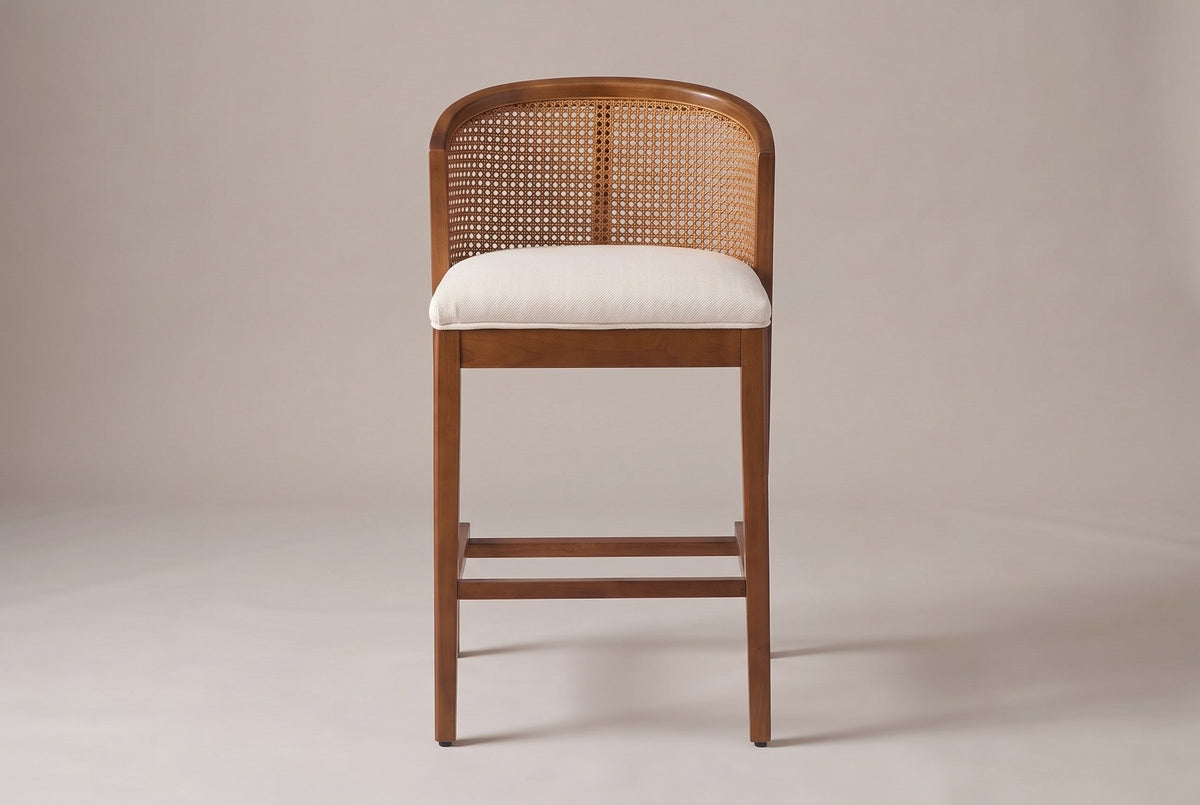 Lazise counter stool in Walnut, straight front view: a low curved cane-look back above a padded beige seat