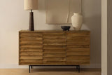 Leander honey acacia sideboard under abstract wall art with a table lamp and ceramics