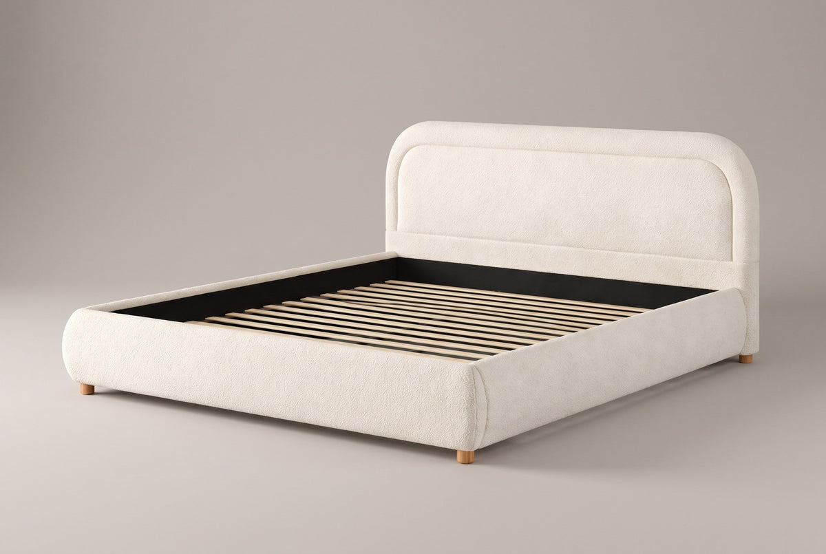 Lerici boucle platform bed in ivory, three-quarter view on a warm grey studio backdrop