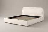 Lerici boucle platform bed in ivory, three-quarter view on a warm grey studio backdrop