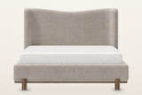 Lerma platform bed, straight front view: the tall headboard with its soft wave