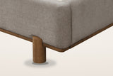Corner of the Lerma bed: the padded rail on a thin walnut-finished wood base