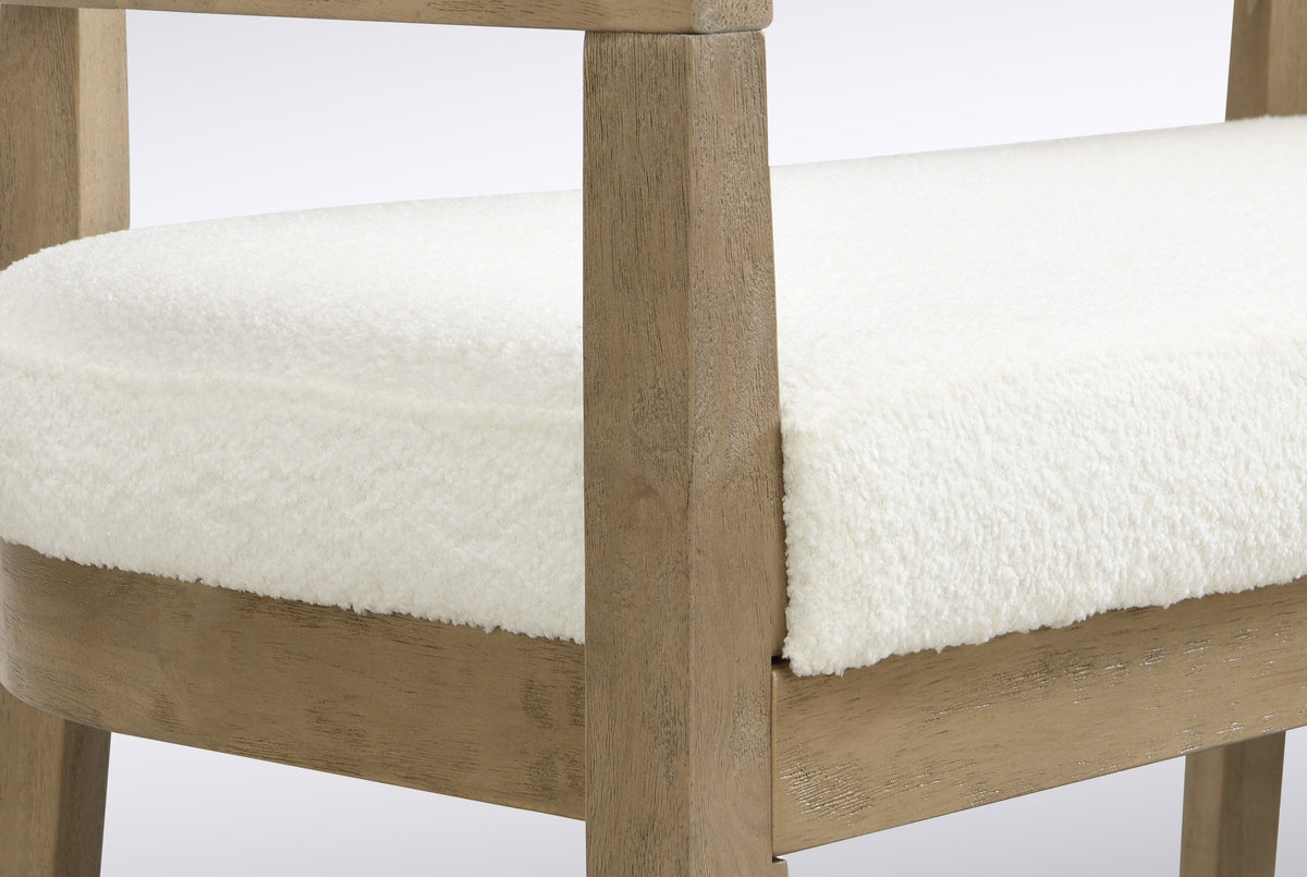 Close-up of the square natural ash-finish front post, the seat rail joint and the beige boucle seat pad