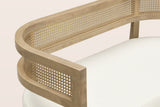 Close-up of the natural woven rattan band between its two ash-finish rails, the squared arm end and the beige boucle seat pad