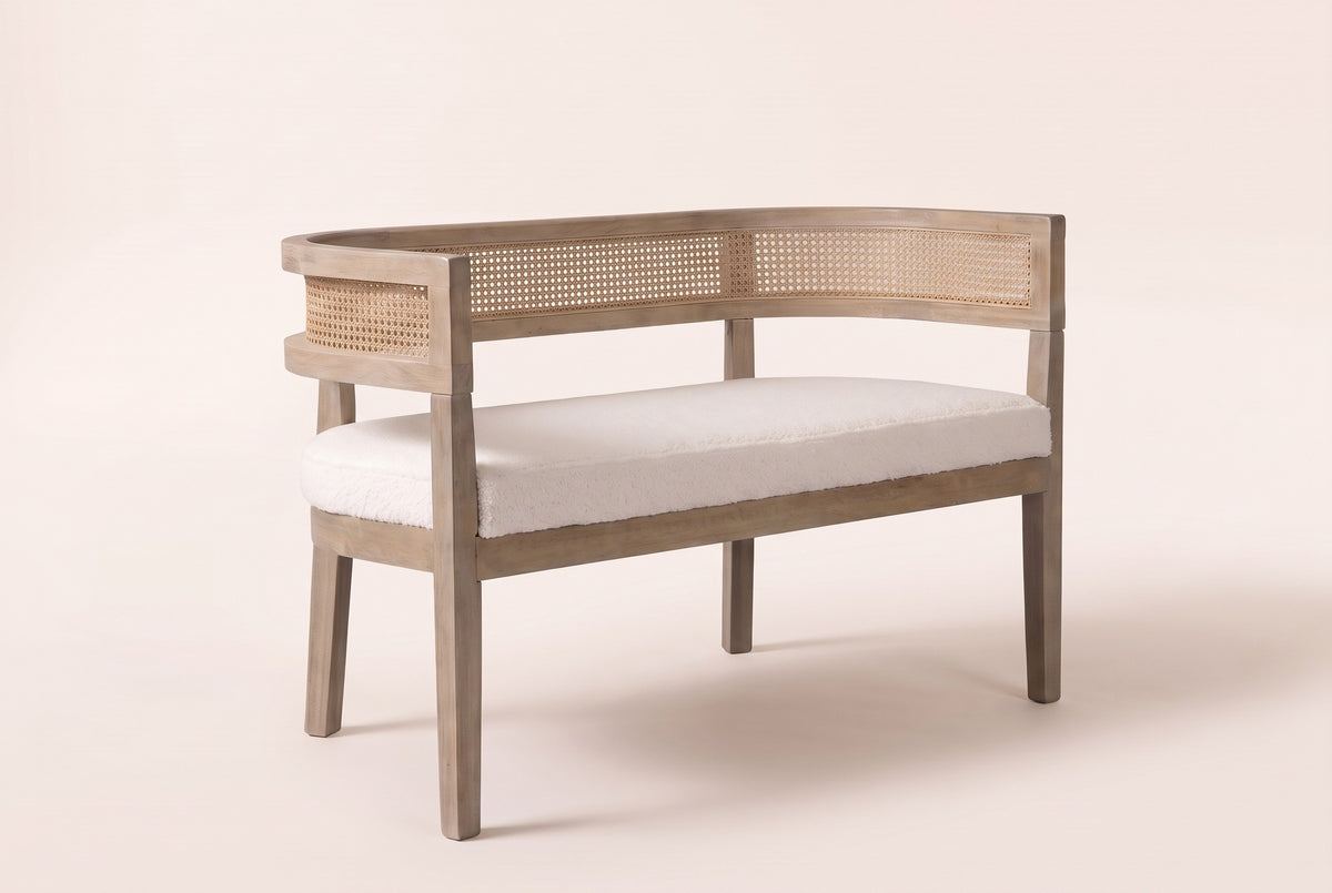 Levanto cane-back loveseat in beige boucle on a natural ash-finish rubberwood frame, three-quarter view on a warm cream studio backdrop