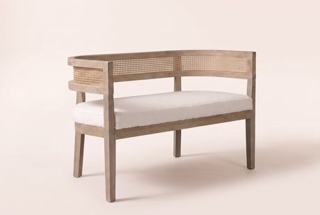 Levanto cane-back loveseat in beige boucle on a natural ash-finish rubberwood frame, three-quarter view on a warm cream studio backdrop