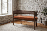 Levanto loveseat against a fieldstone wall in a Quebec City living room in winter light