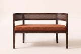 Levanto loveseat, straight front view: a woven rattan band wrapping the back and arms, one long seat pad and four square legs