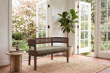 Levanto loveseat in green and walnut in a Victoria garden room with open French doors, a flowering dogwood and a travertine side table