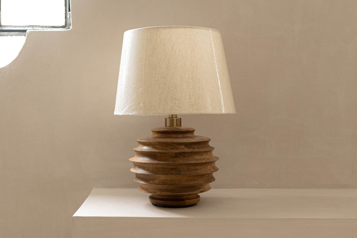 Linden ridged wood table lamp on a plaster ledge in soft daylight
