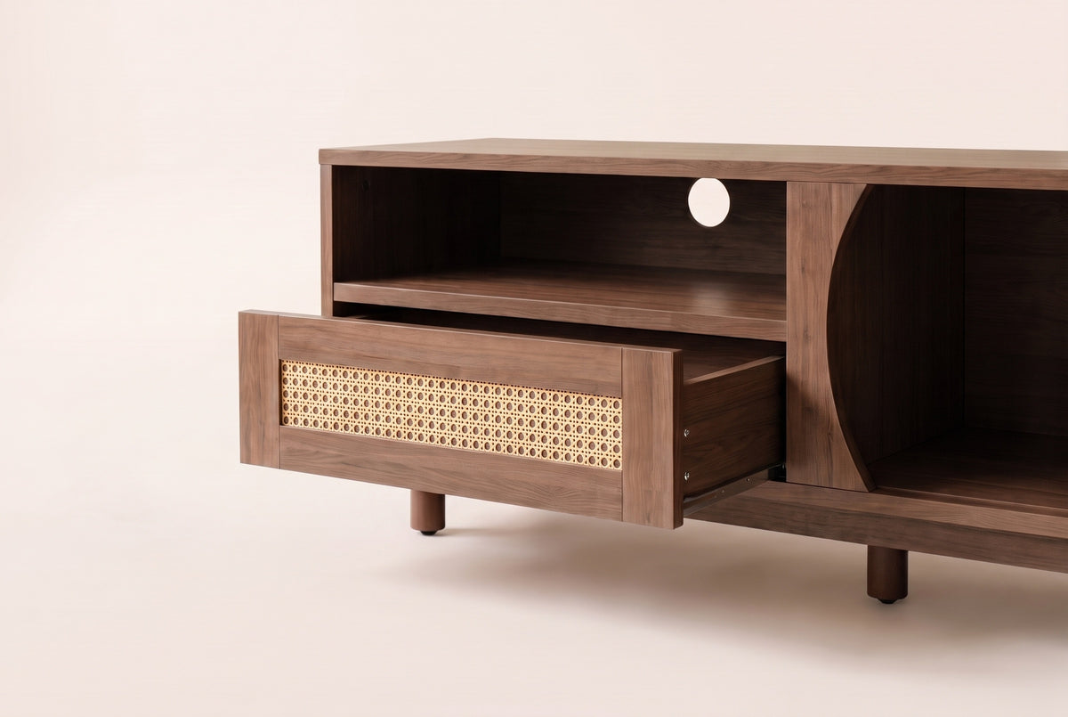 Close-up of the Livia console's centre: the hand-woven rattan drawer pulled out below the open shelf