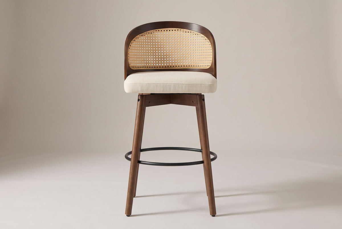 Locorotondo counter stool, straight front view: low barrel back with cane-look panel, cream woven seat, wood apron