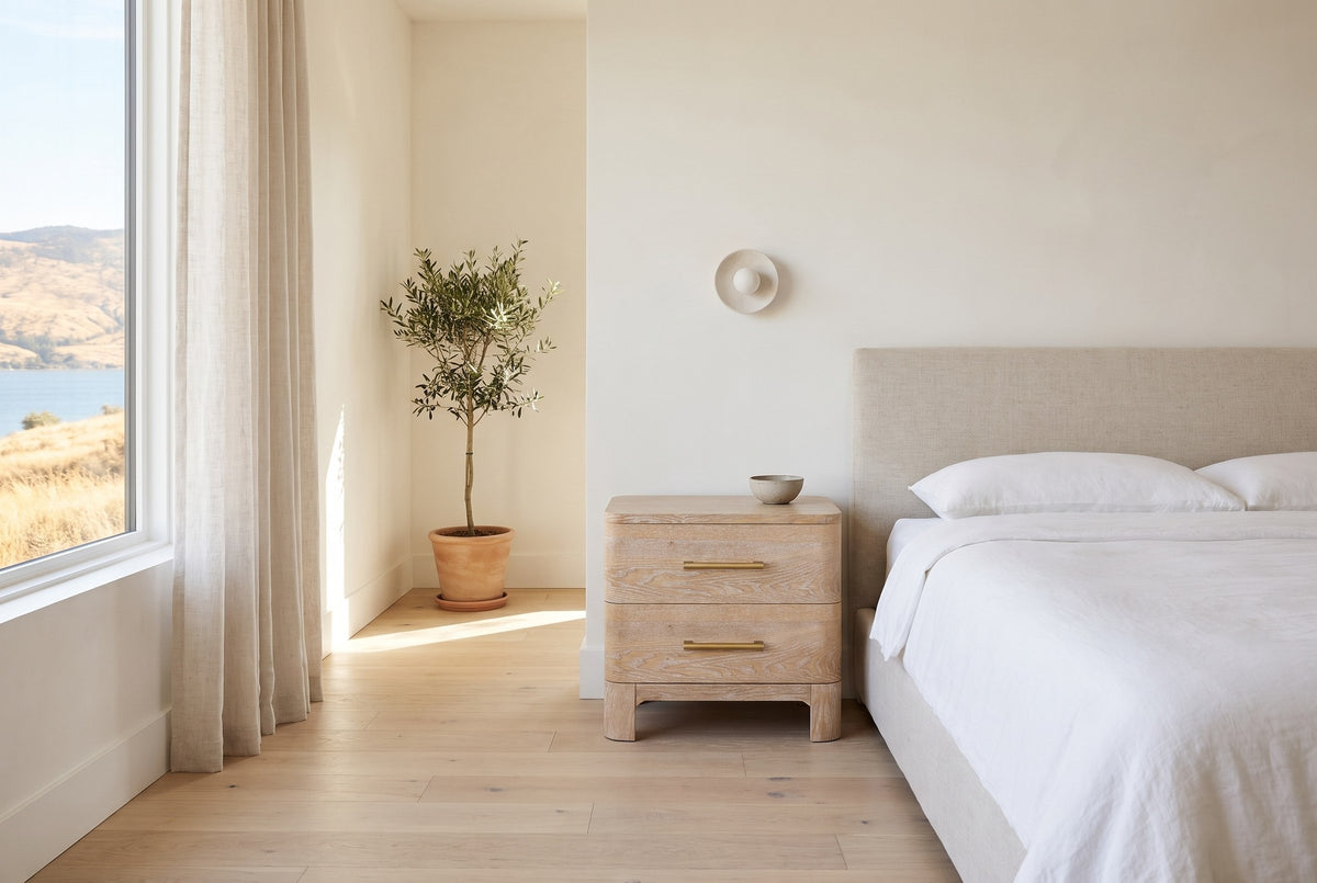 Lodi nightstand in Natural beside a bed with white linen in a bright Kelowna lake-house bedroom