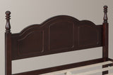 Close-up of the walnut Loreto headboard: three arched panels, a thin bead moulding and two turned finials