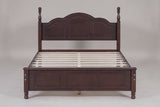 Loreto bed in walnut, straight front view: arched three-panel headboard, turned finials and five-field footboard