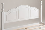 Close-up of the white Loreto headboard: three arched panels, a thin bead moulding and two turned finials