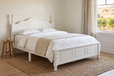 Loreto bed in white in a shiplap farmhouse bedroom with a jute rug and a view of vineyards and dry hills