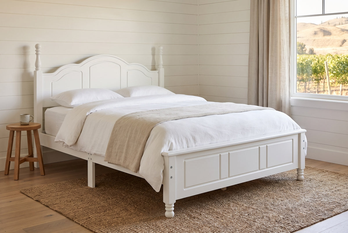 Loreto bed in white in a shiplap farmhouse bedroom with a jute rug and a view of vineyards and dry hills