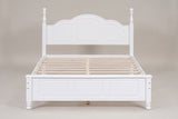 Loreto bed in white, straight front view: arched three-panel headboard, turned finials and five-field footboard