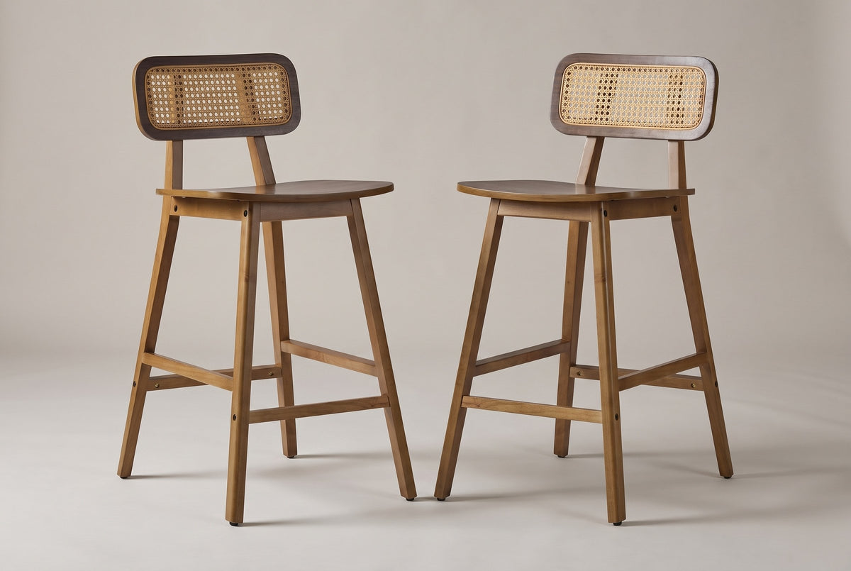 A pair of Lovere counter stools in Walnut, three-quarter view on a warm grey studio backdrop